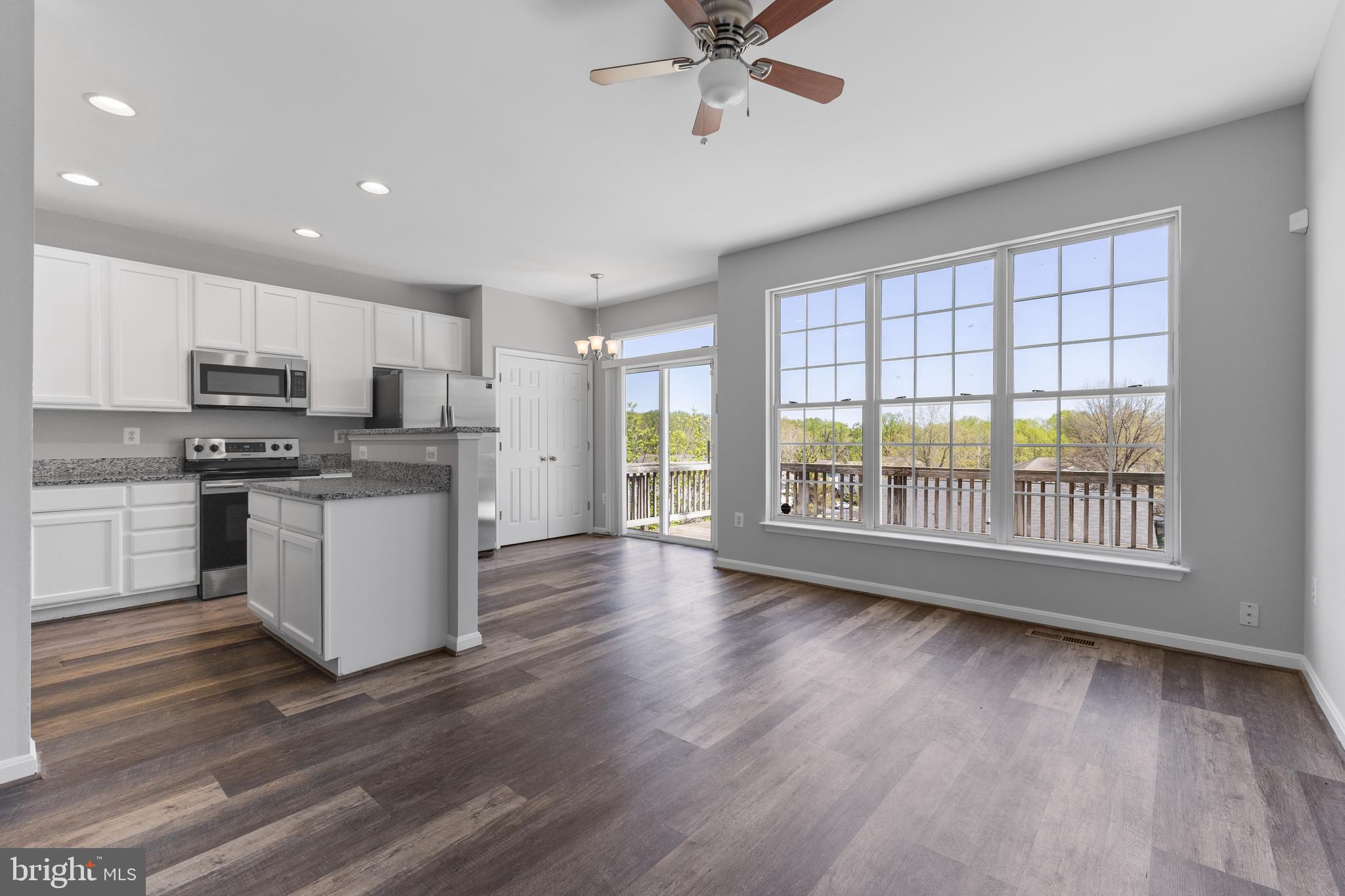 2925 Rotterdam Loop Woodbridge, VA 22191 - Photo 15 of 55 a open kitchen with granite countertop a stove top oven a sink a counter space and cabinets