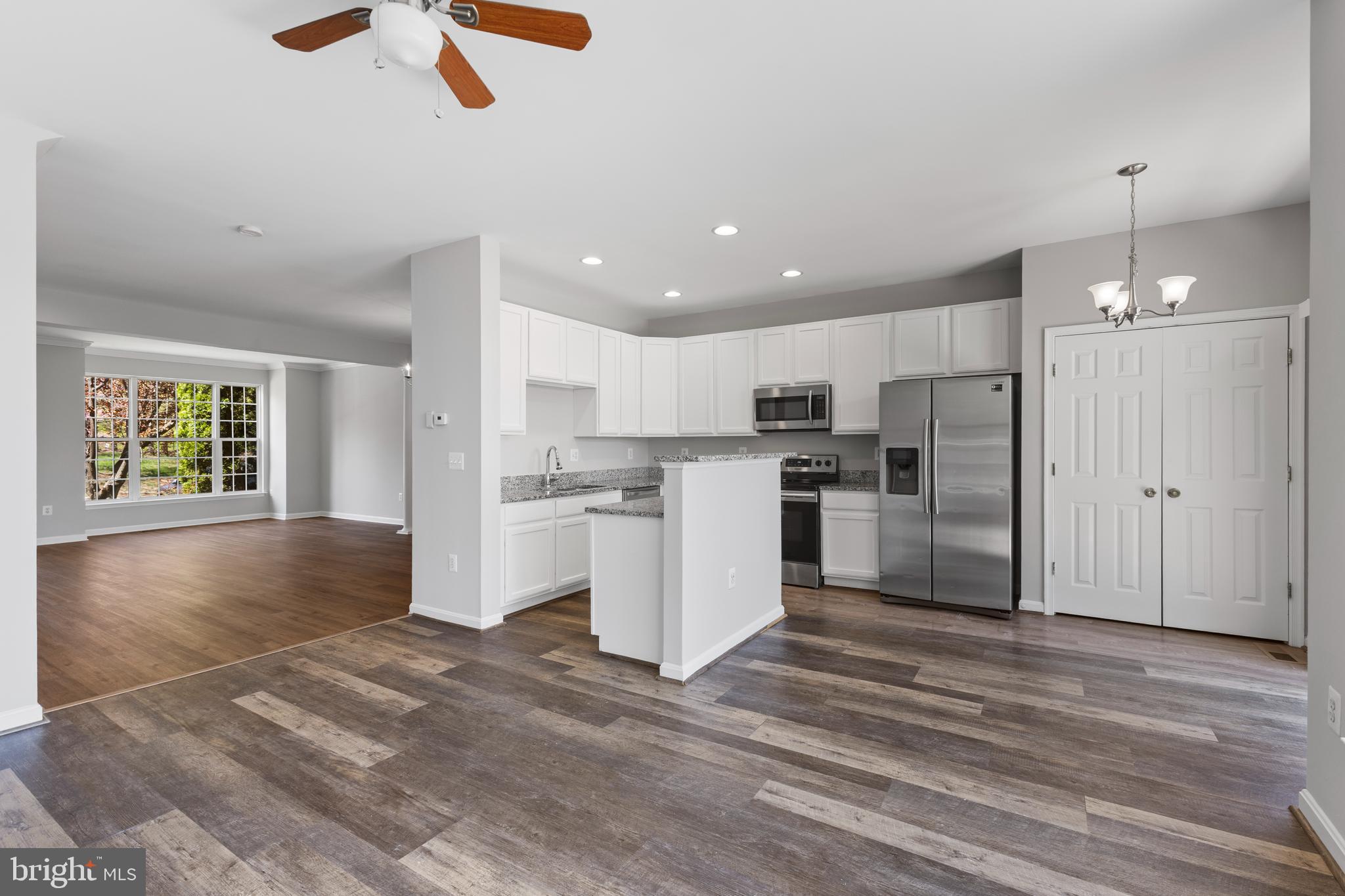 2925 Rotterdam Loop Woodbridge, VA 22191 - Photo 19 of 55 a kitchen with stainless steel appliances kitchen island a refrigerator sink and cabinets