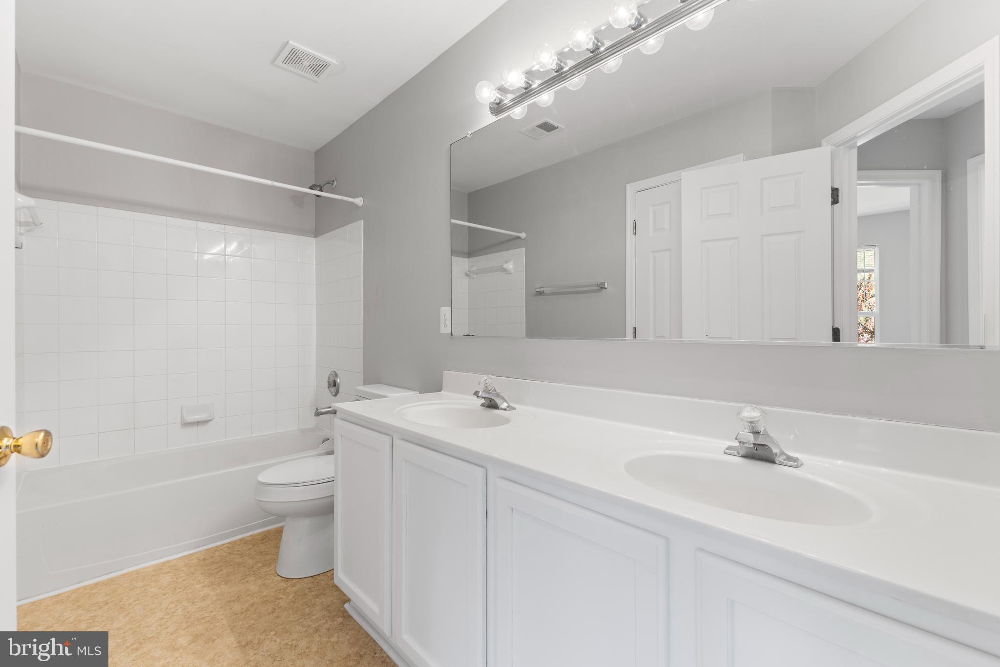 2925 Rotterdam Loop Woodbridge, VA 22191 - Photo 23 of 55 a bathroom with a sink a toilet a shower and a mirror