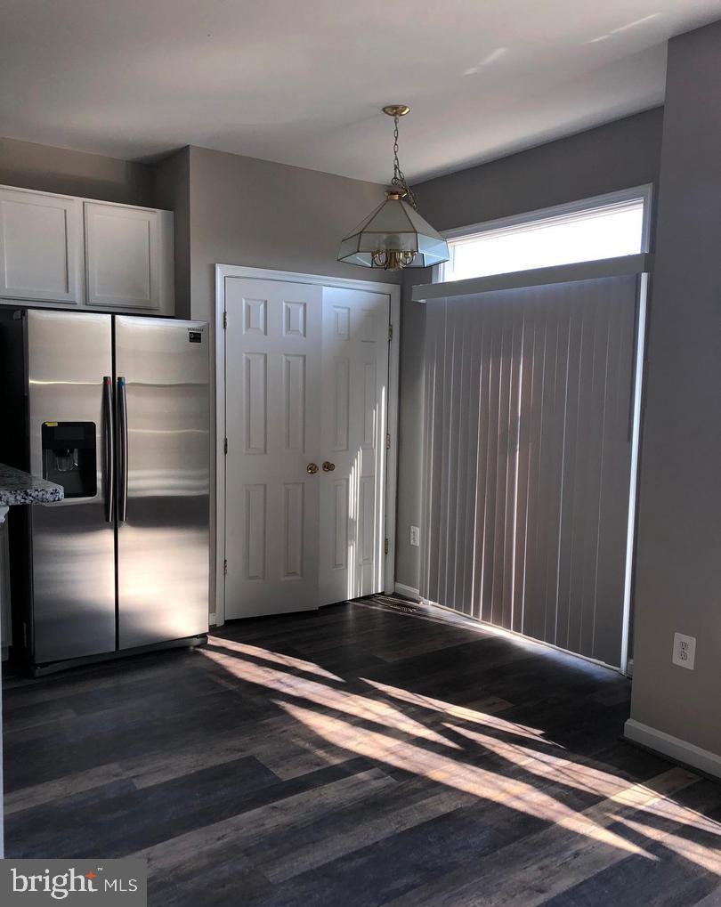 2925 Rotterdam Loop Woodbridge, VA 22191 - Photo 29 of 55 a view of a refrigerator in kitchen and wooden floor