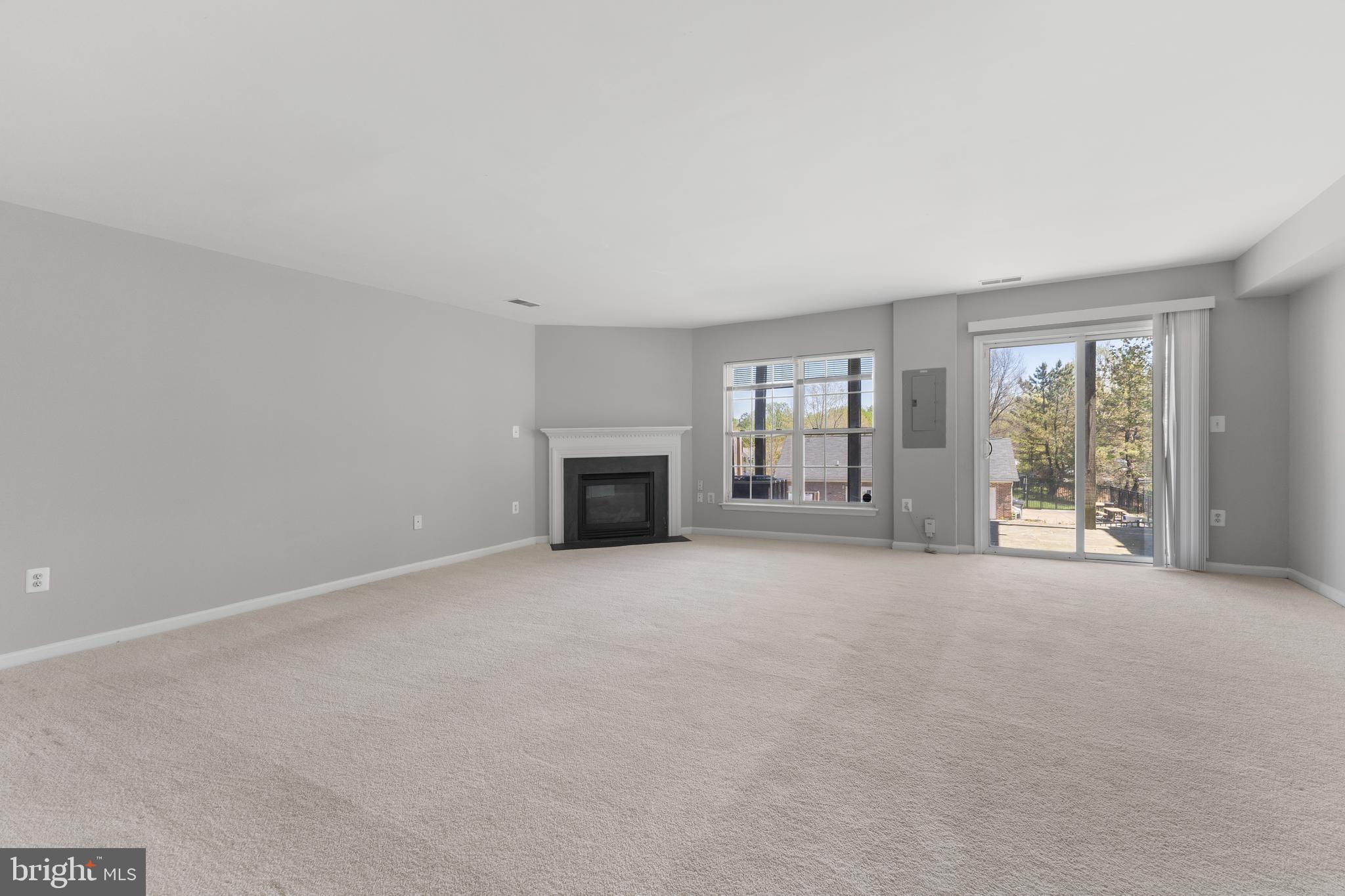 2925 Rotterdam Loop Woodbridge, VA 22191 - Photo 37 of 55 an empty room with floor to ceiling window and fireplace