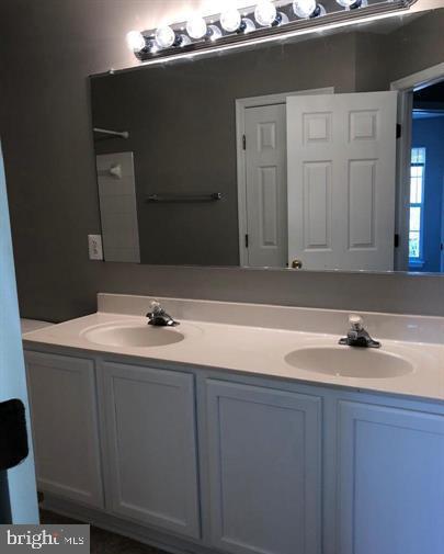 2925 Rotterdam Loop Woodbridge, VA 22191 - Photo 50 of 55 a bathroom with a sink and a mirror