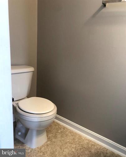 2925 Rotterdam Loop Woodbridge, VA 22191 - Photo 55 of 55 a toilet sitting in a bathroom next to a wooden wall