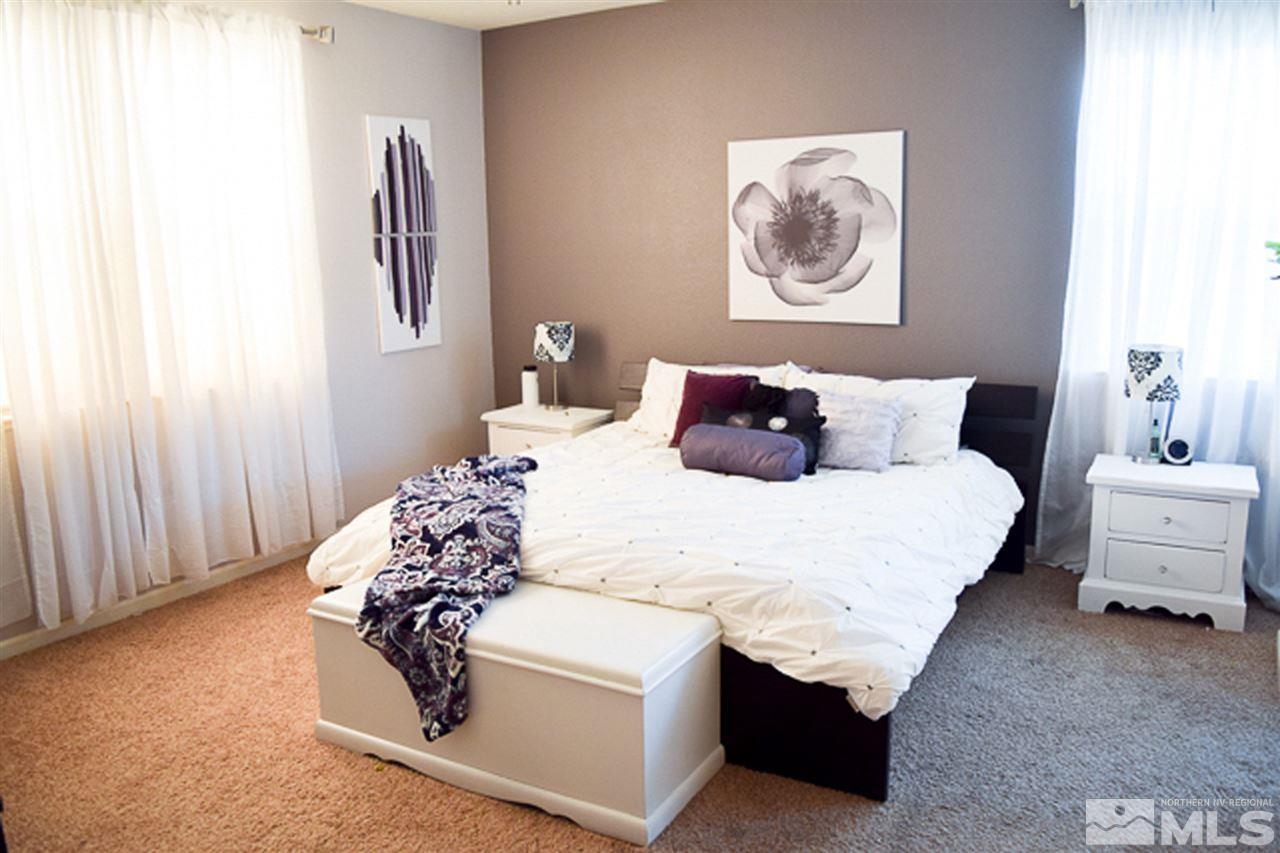 11180 Parma Way Reno, NV 89521 - Photo 16 of 37 a bedroom with a bed and a couch