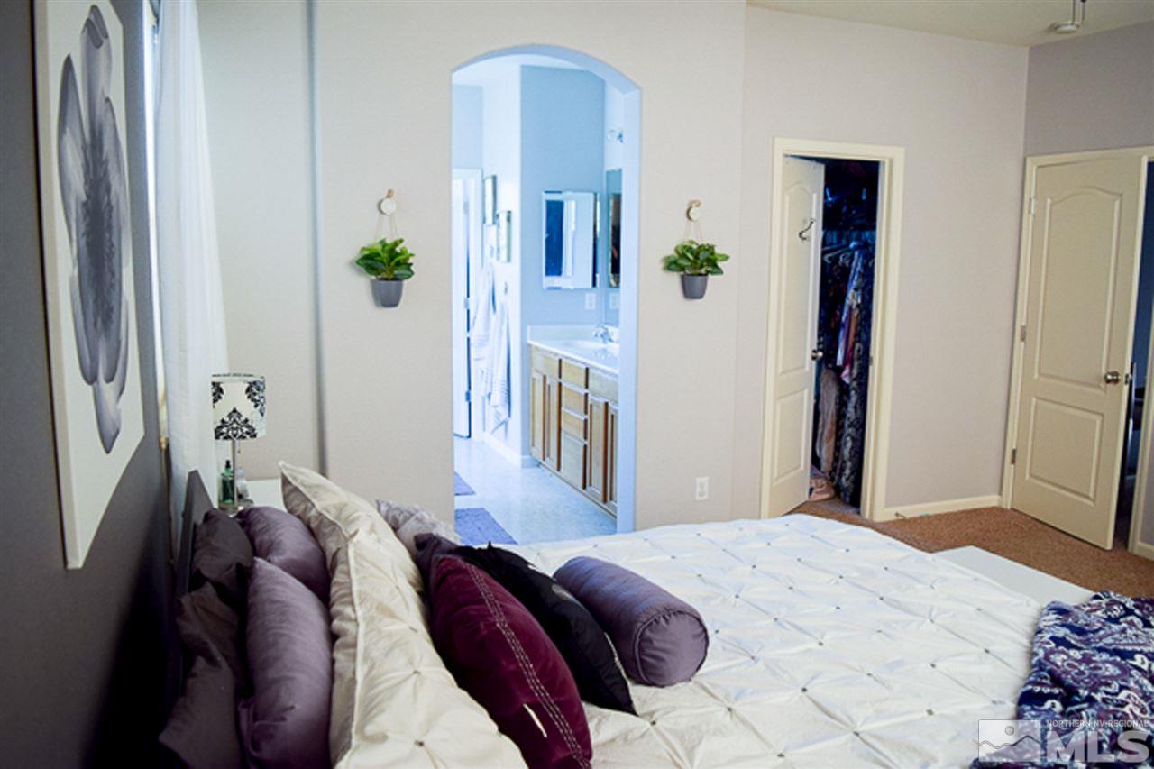 11180 Parma Way Reno, NV 89521 - Photo 17 of 37 a bedroom with a bed and a mirror