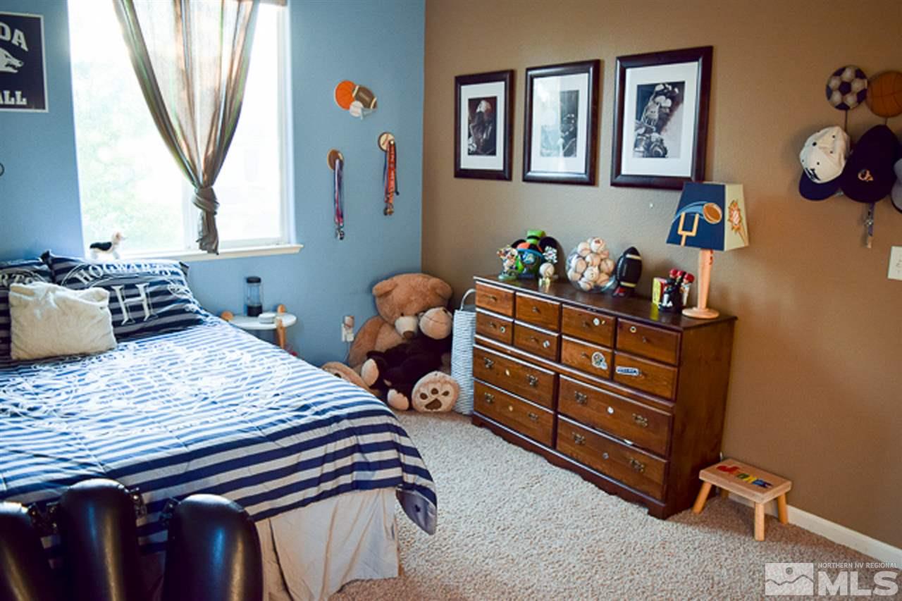 11180 Parma Way Reno, NV 89521 - Photo 22 of 37 a bed room with a bed and a window