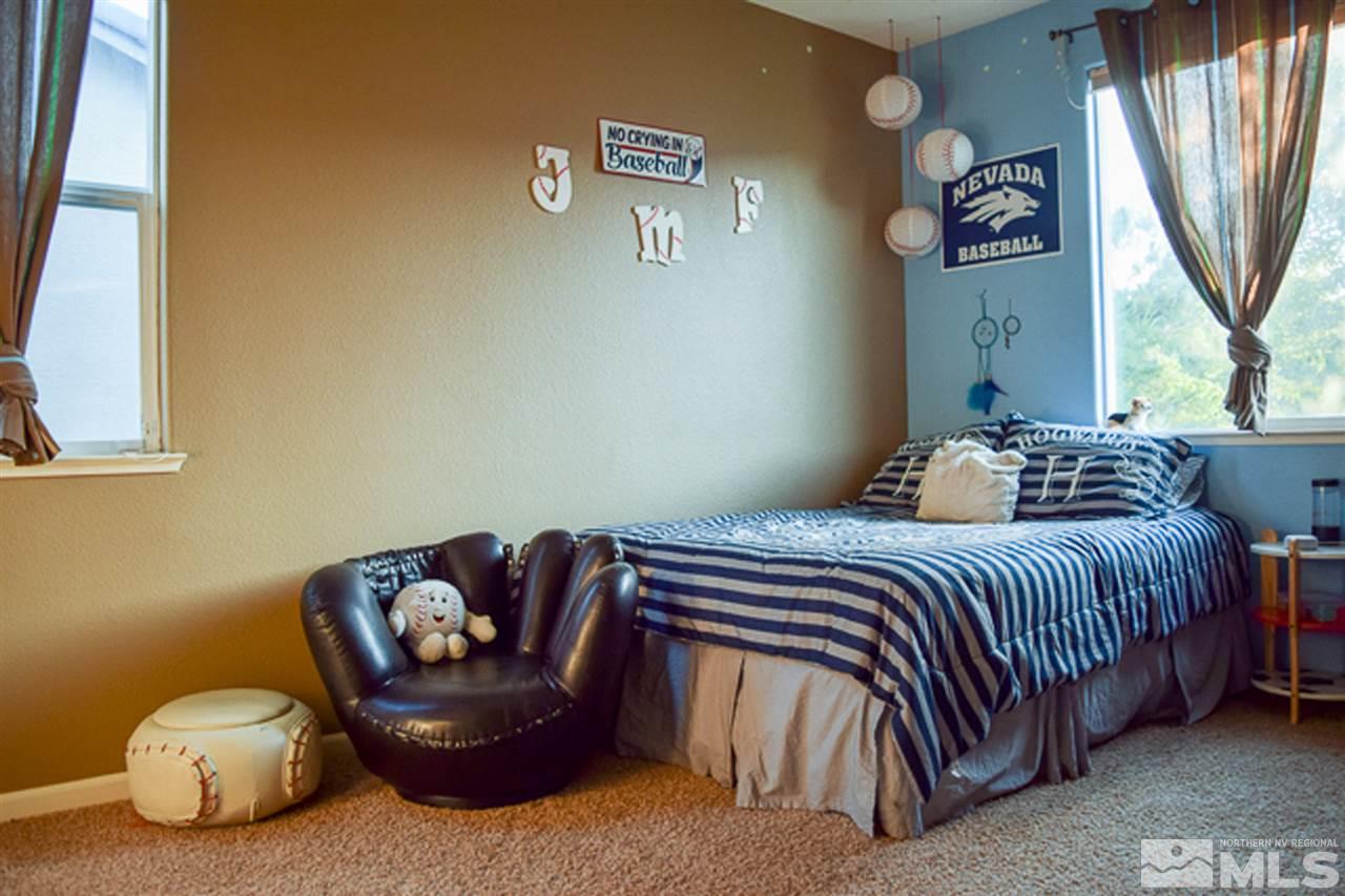 11180 Parma Way Reno, NV 89521 - Photo 23 of 37 a bedroom with a bed and window