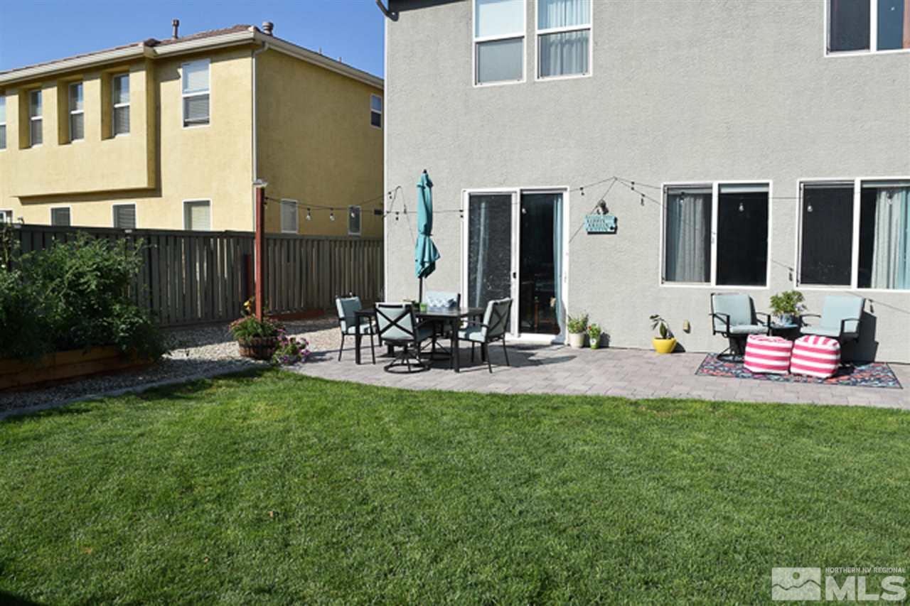 11180 Parma Way Reno, NV 89521 - Photo 31 of 37 a view of a backyard with table and chairs and potted plants
