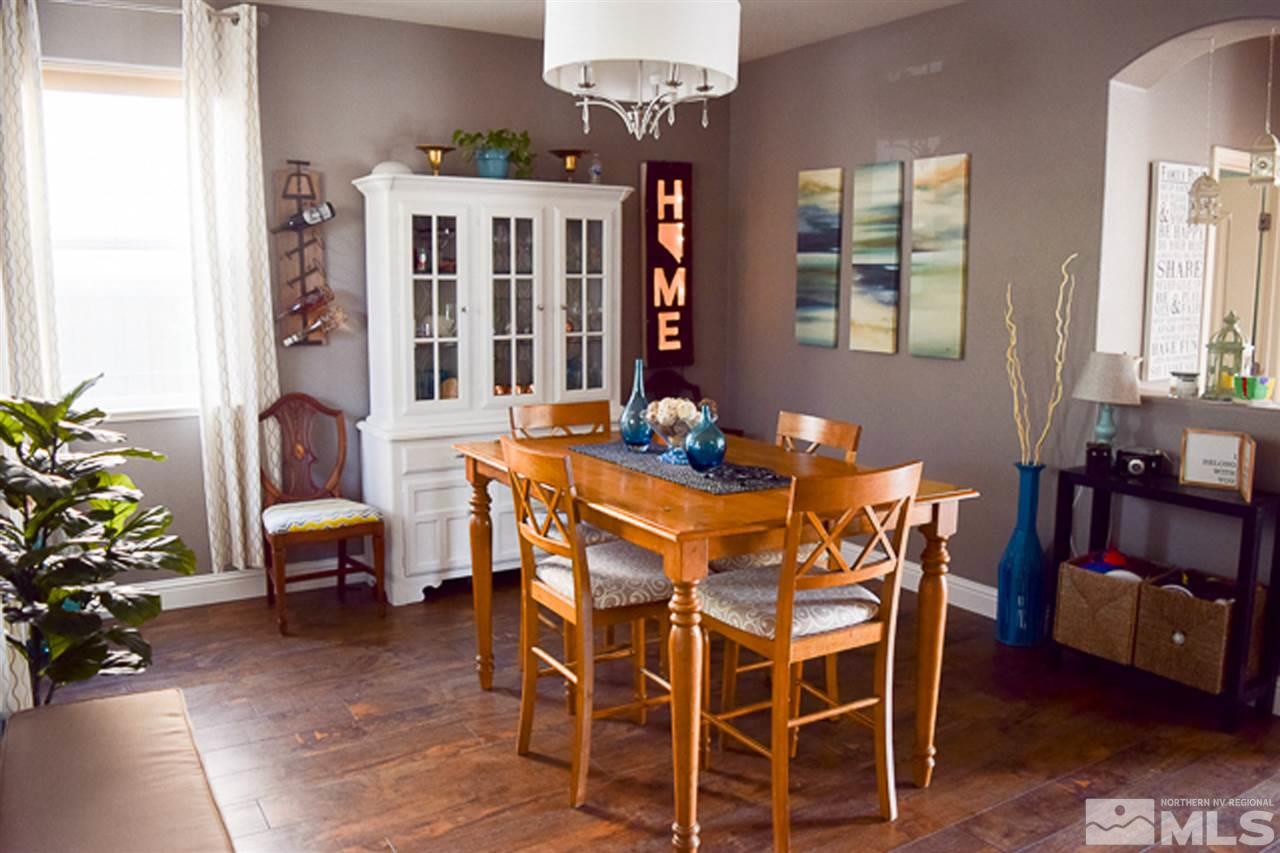 11180 Parma Way Reno, NV 89521 - Photo 6 of 37 a view of a dining room with furniture and chandelier