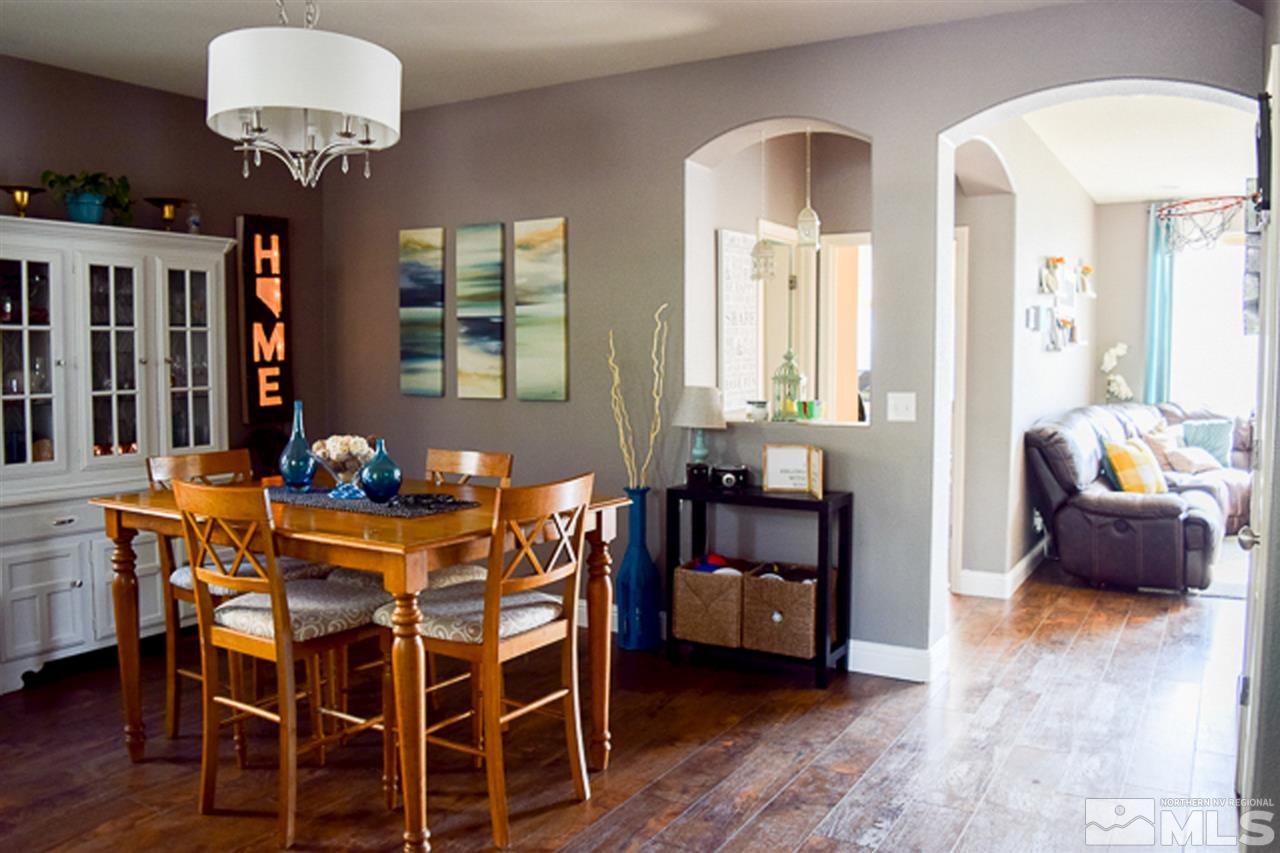 11180 Parma Way Reno, NV 89521 - Photo 7 of 37 a view of a dining room with furniture and chandelier