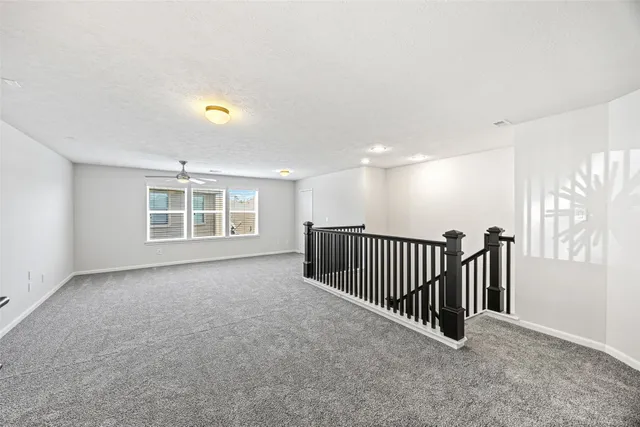 a view of a ceiling fan and a window in a room
