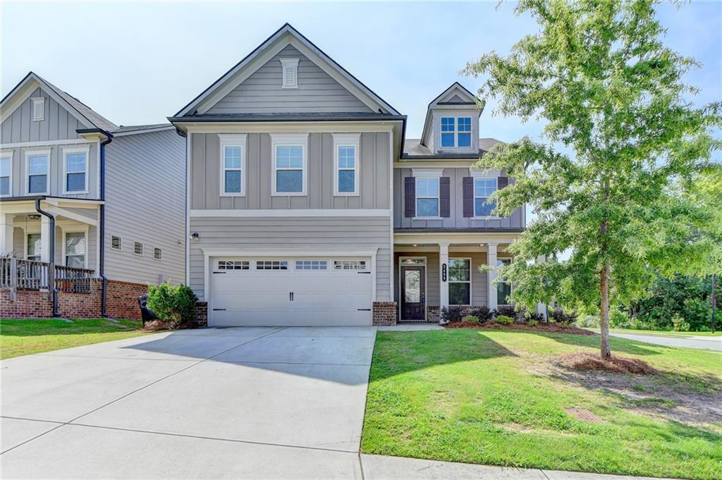 2409 Ivy Meadow Lane Buford, GA 30519 - Photo 1 of 32 a front view of a house with a yard and trees