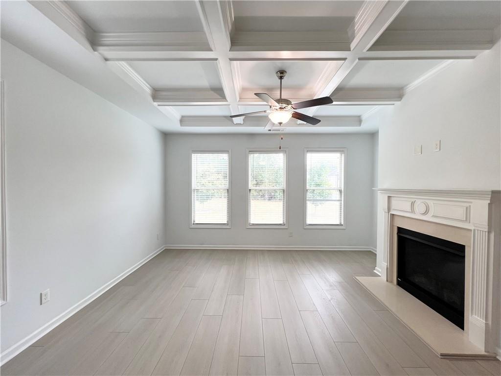 2409 Ivy Meadow Lane Buford, GA 30519 - Photo 14 of 32 a view of an empty room with wooden floor and a window