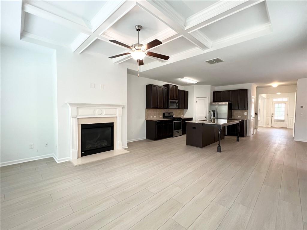 2409 Ivy Meadow Lane Buford, GA 30519 - Photo 15 of 32 a living room with furniture a fireplace and a flat screen tv