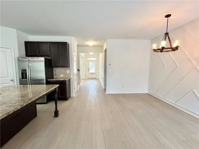a kitchen with kitchen island a counter top space appliances and cabinets