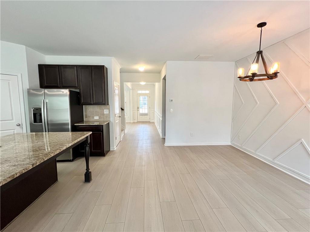 2409 Ivy Meadow Lane Buford, GA 30519 - Photo 16 of 32 a kitchen with kitchen island a counter top space appliances and cabinets