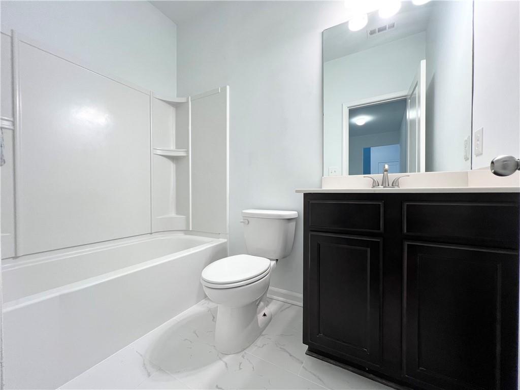 2409 Ivy Meadow Lane Buford, GA 30519 - Photo 18 of 32 a bathroom with a sink and a mirror