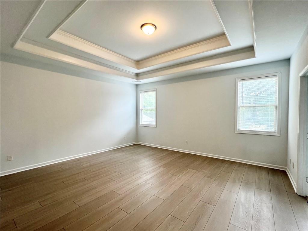 2409 Ivy Meadow Lane Buford, GA 30519 - Photo 20 of 32 a view of an empty room with wooden floor and a window