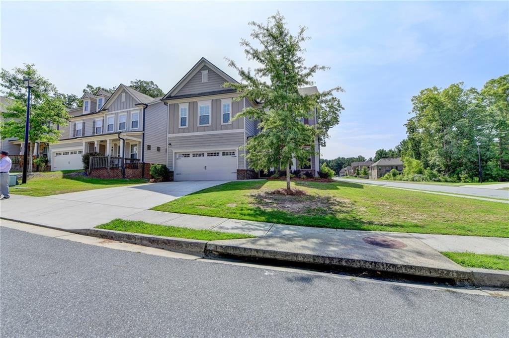 2409 Ivy Meadow Lane Buford, GA 30519 - Photo 2 of 32 a front view of a house with a yard and garage