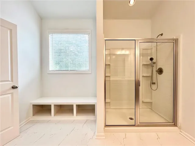 a bathroom with a shower and a mirror