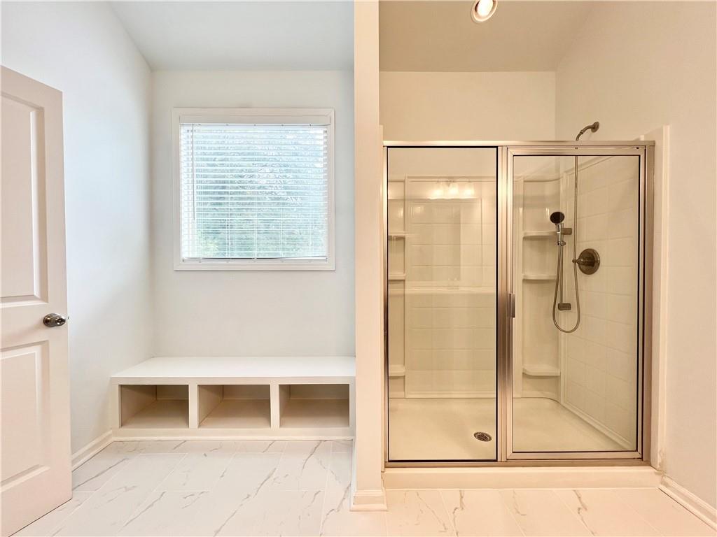 2409 Ivy Meadow Lane Buford, GA 30519 - Photo 22 of 32 a bathroom with a shower and a mirror