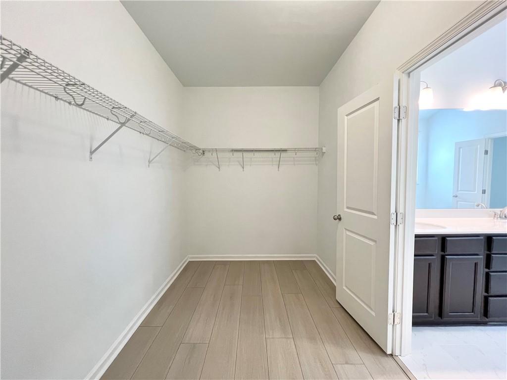 2409 Ivy Meadow Lane Buford, GA 30519 - Photo 24 of 32 a view of a room with wooden floor and brick walls
