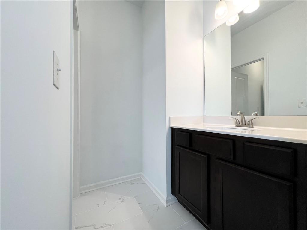 2409 Ivy Meadow Lane Buford, GA 30519 - Photo 26 of 32 a bathroom with a sink and a mirror