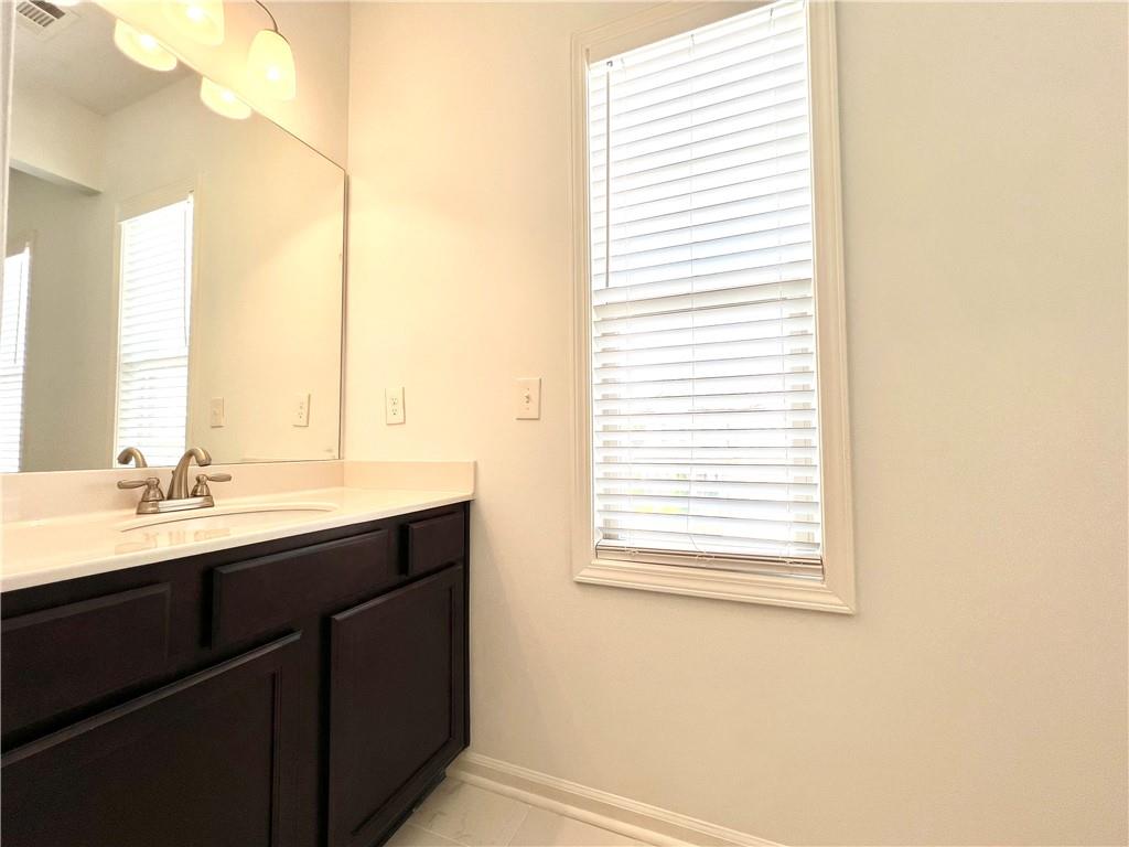 2409 Ivy Meadow Lane Buford, GA 30519 - Photo 27 of 32 a bathroom with a sink and a mirror