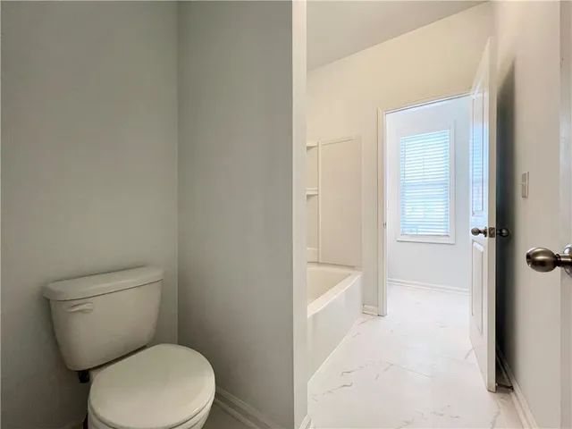 a white toilet sitting next to a bathroom sink