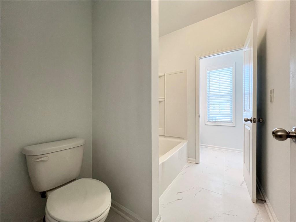 2409 Ivy Meadow Lane Buford, GA 30519 - Photo 28 of 32 a white toilet sitting next to a bathroom sink