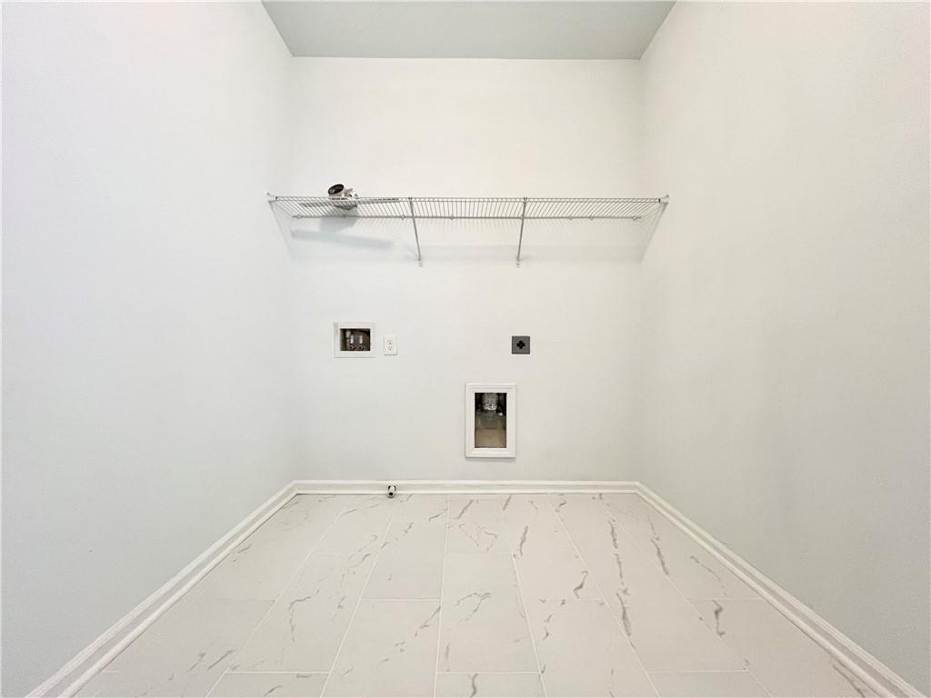 2409 Ivy Meadow Lane Buford, GA 30519 - Photo 30 of 32 a view of a room with racks on the wall