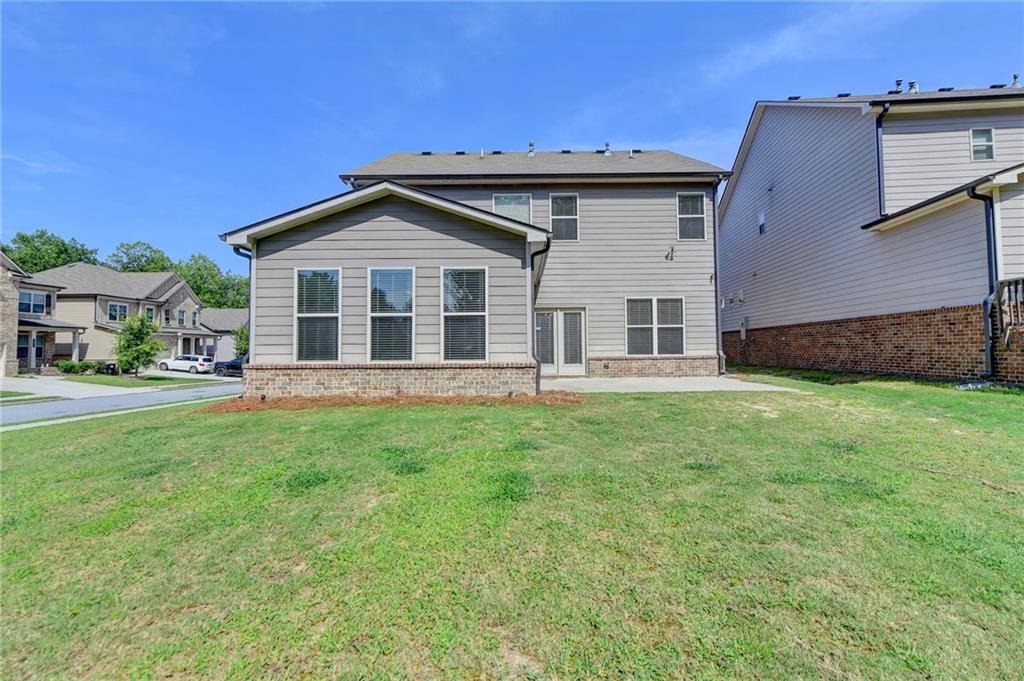 2409 Ivy Meadow Lane Buford, GA 30519 - Photo 31 of 32 a front view of a house with a garden