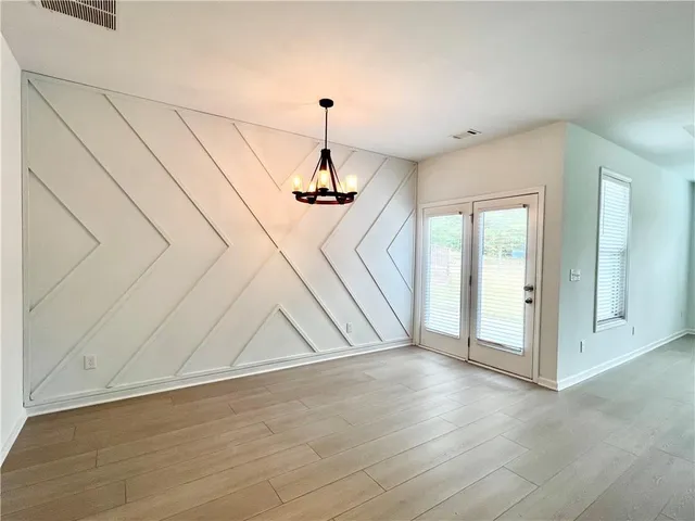 a view of an empty room with glass door