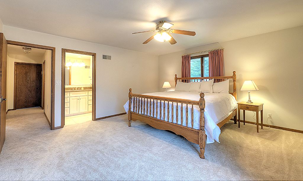 4215 Landstrom Road Rockford, IL 61114 - Photo 13 of 25 a bedroom with a bed and a chandelier