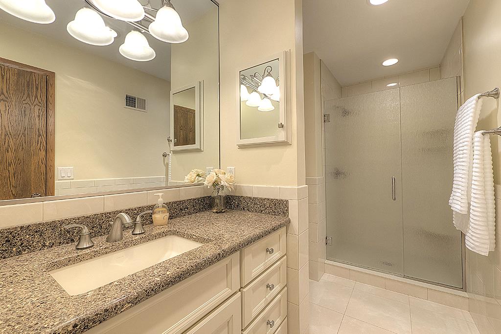 4215 Landstrom Road Rockford, IL 61114 - Photo 14 of 25 a bathroom with a granite countertop sink mirror and shower