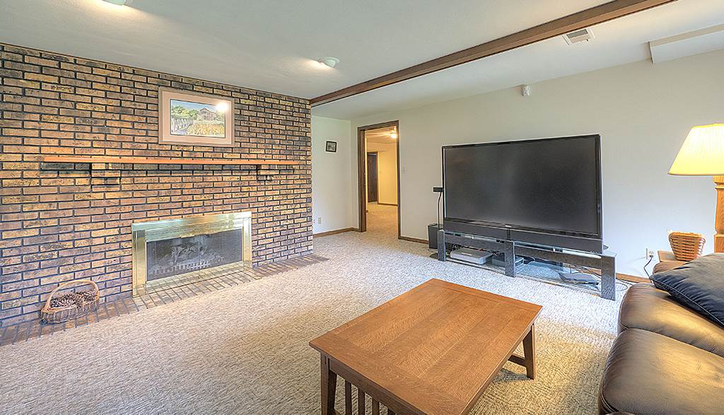 4215 Landstrom Road Rockford, IL 61114 - Photo 20 of 25 a living room with furniture and a flat screen tv