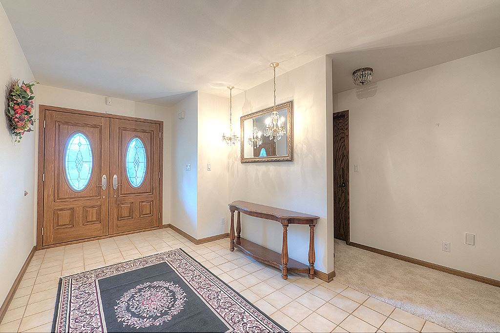 4215 Landstrom Road Rockford, IL 61114 - Photo 3 of 25 a spacious bedroom with a bed and a table in it