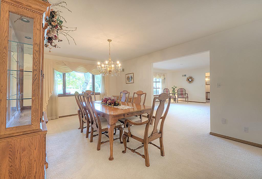 4215 Landstrom Road Rockford, IL 61114 - Photo 5 of 25 a view of a dining room with furniture a chandelier and a window