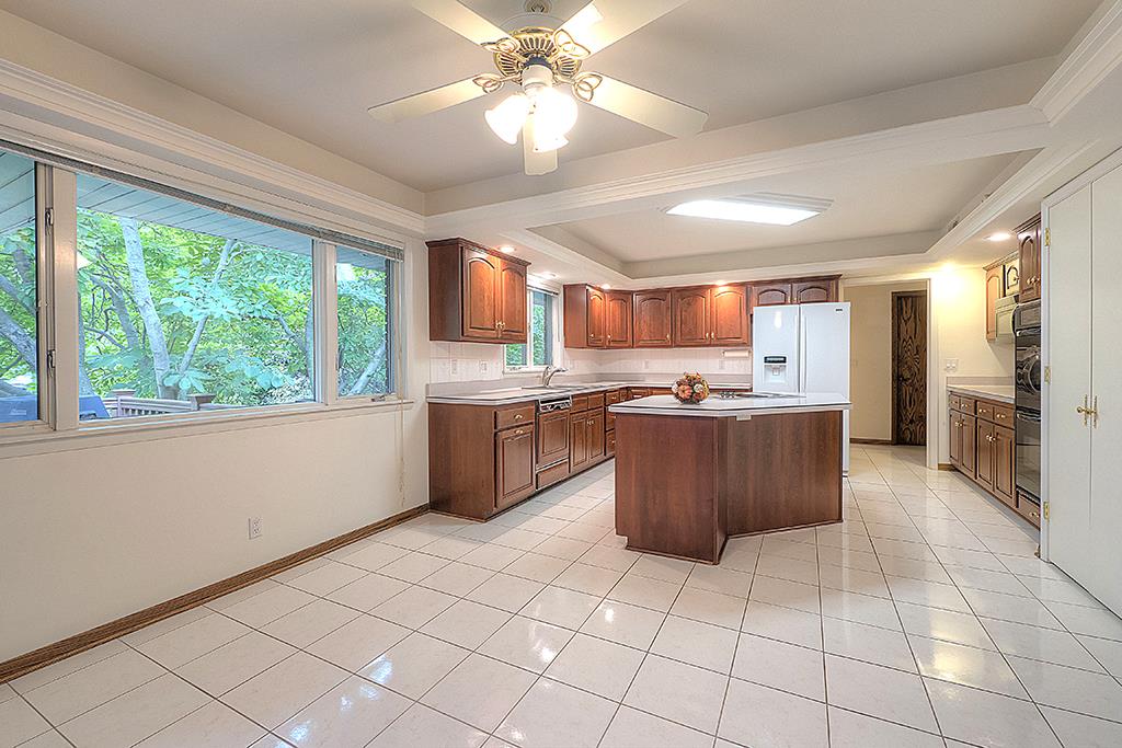4215 Landstrom Road Rockford, IL 61114 - Photo 9 of 25 a large kitchen with stainless steel appliances granite countertop a stove a sink dishwasher and a refrigerator