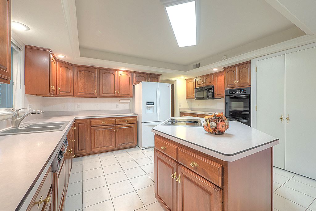 4215 Landstrom Road Rockford, IL 61114 - Photo 10 of 25 a kitchen with stainless steel appliances granite countertop a sink stove and refrigerator