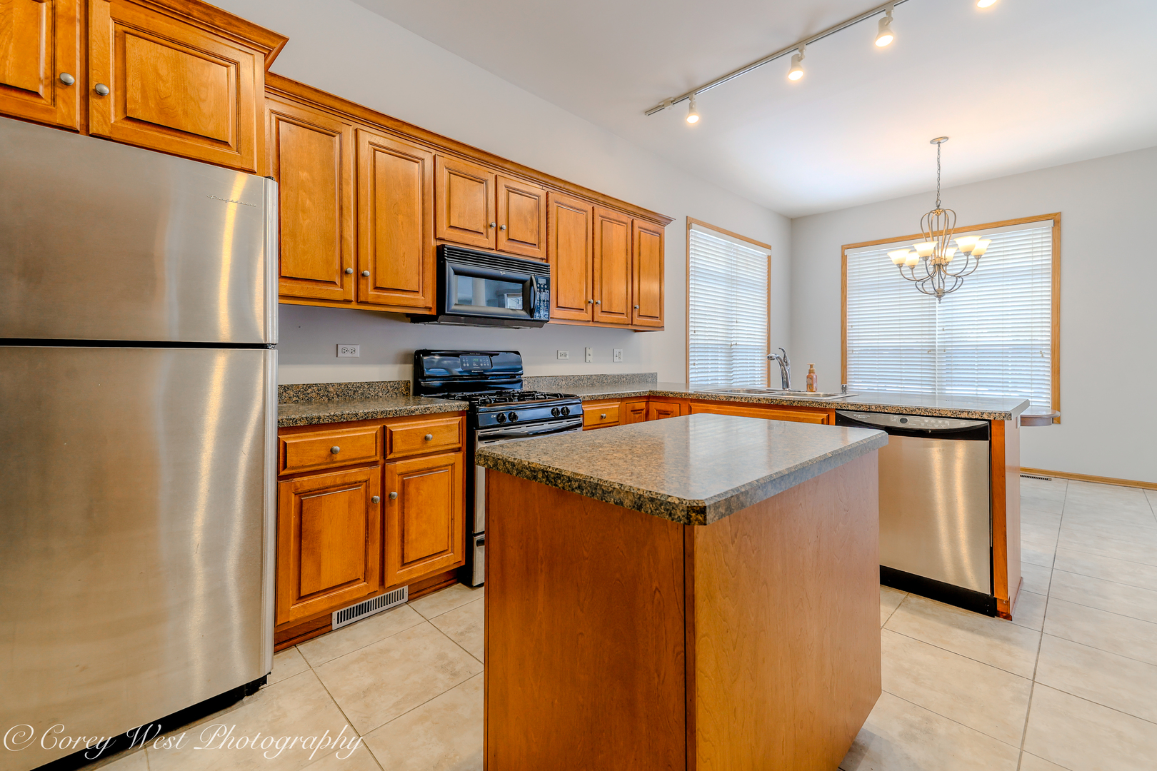 620 Ridge Drive Elburn, IL 60119 - Photo 17 of 46 a kitchen with stainless steel appliances granite countertop a refrigerator a sink a stove and white cabinets