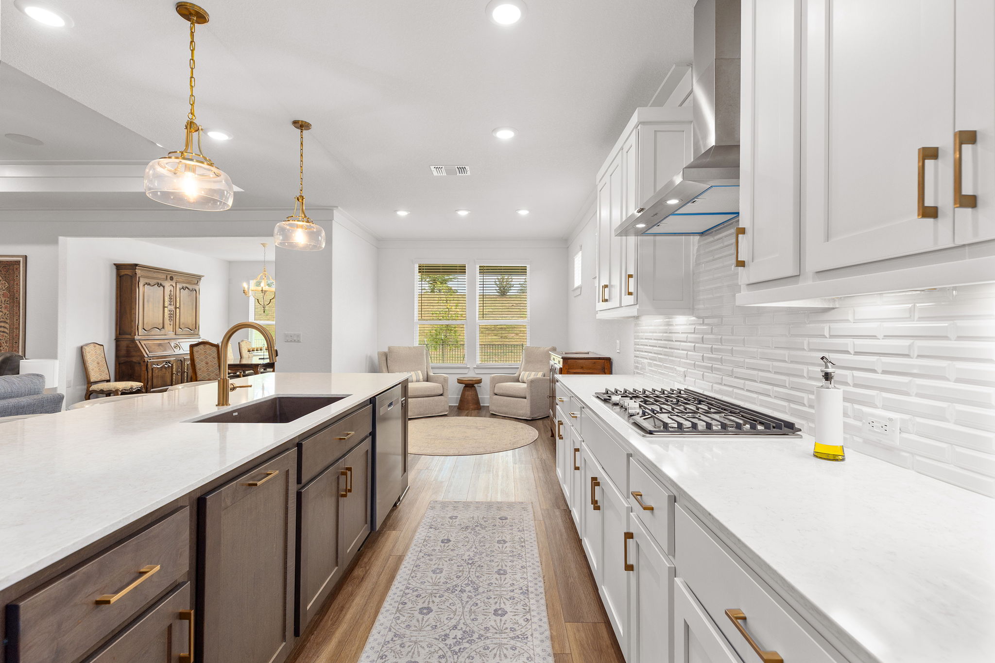 640 Martingale Street Georgetown, TX 78633 - Photo 39 of 39 Two tone kitchen featuring two tone cabinetry, open floor plan, light wood-style flooring, light stone countertops, and stainless steel appliances