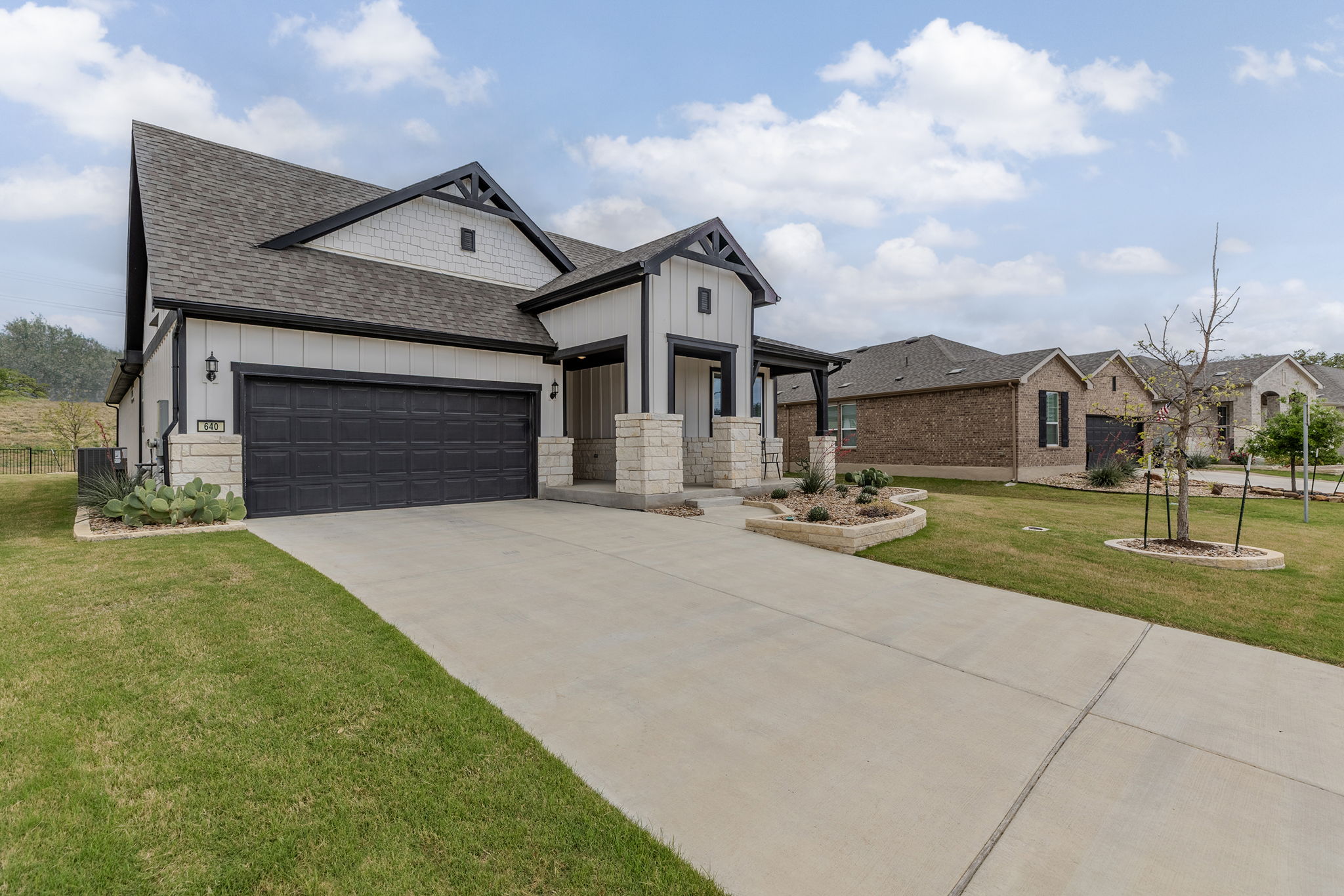 640 Martingale Street Georgetown, TX 78633 - Photo 2 of 39 Modern farmhouse style home featuring a shingled roof, board and batten siding, a porch, and an attached garage