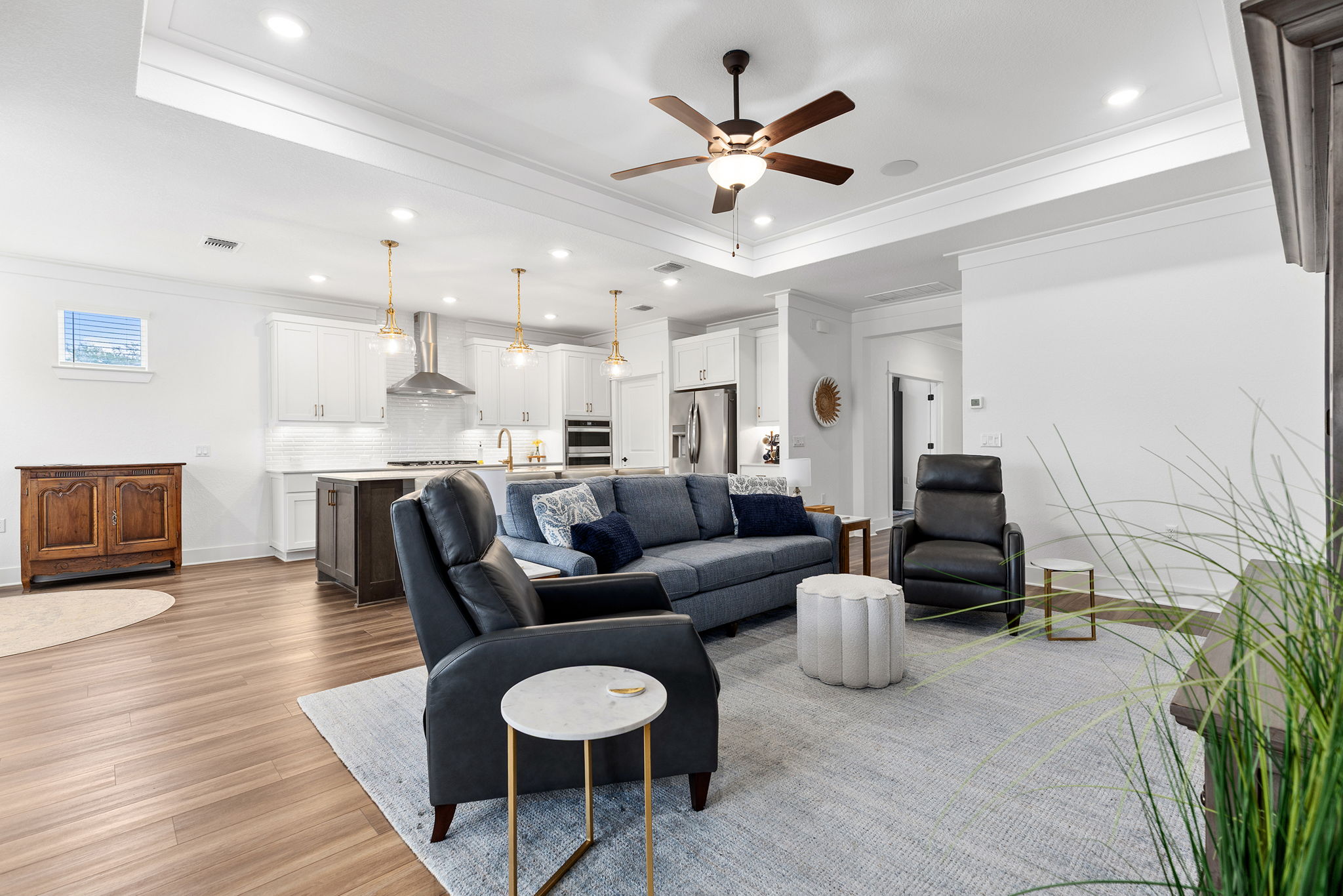 640 Martingale Street Georgetown, TX 78633 - Photo 25 of 39 Living area with ceiling fan, dark wood-type flooring, ornamental molding, recessed lighting, and a raised ceiling