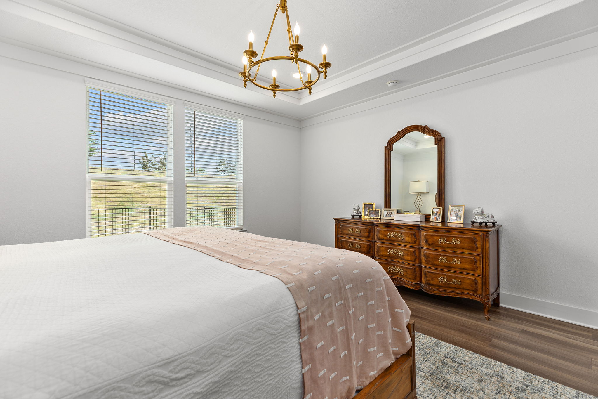 640 Martingale Street Georgetown, TX 78633 - Photo 30 of 39 Bedroom featuring a chandelier, dark wood-style floors, ornamental molding, and a raised ceiling