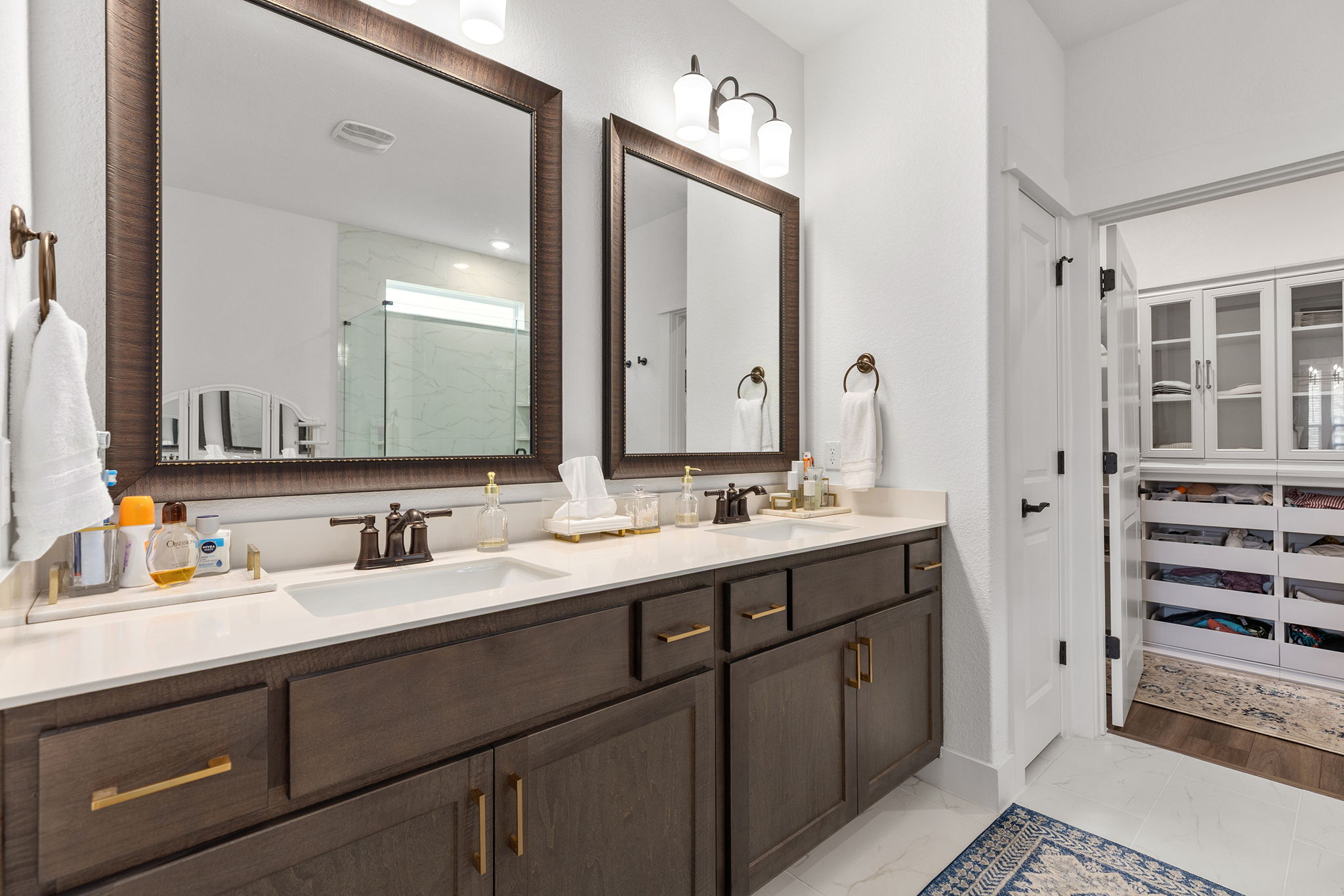 640 Martingale Street Georgetown, TX 78633 - Photo 32 of 39 Full bathroom featuring double vanity, a marble finish shower, a spacious closet, and light marble finish flooring