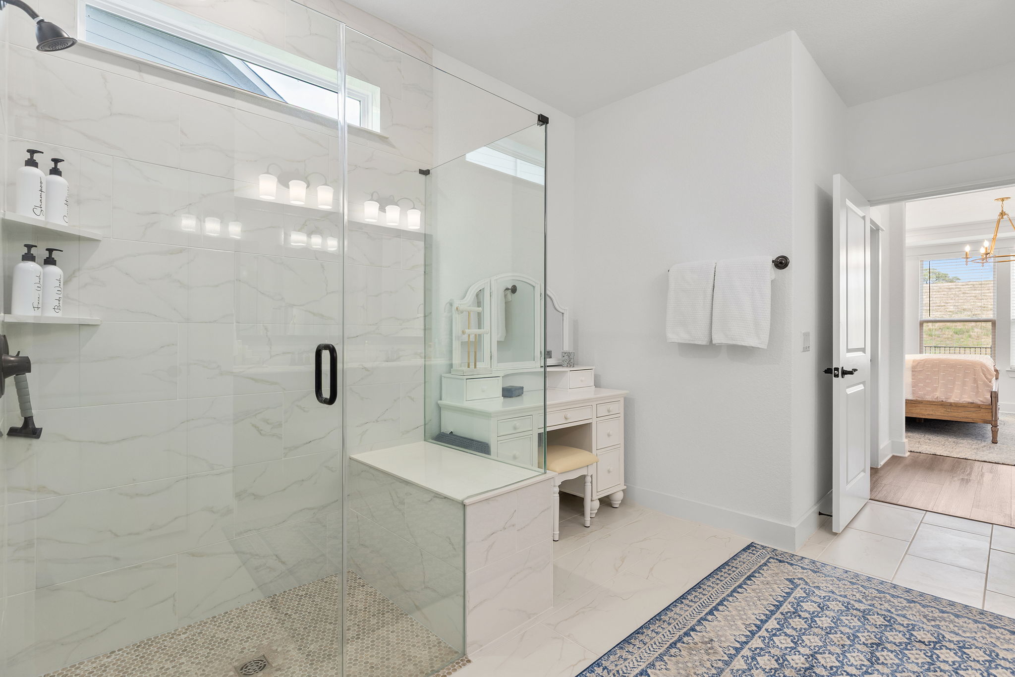 640 Martingale Street Georgetown, TX 78633 - Photo 33 of 39 Full bath with healthy amount of natural light, connected bathroom, a marble finish shower, and a chandelier