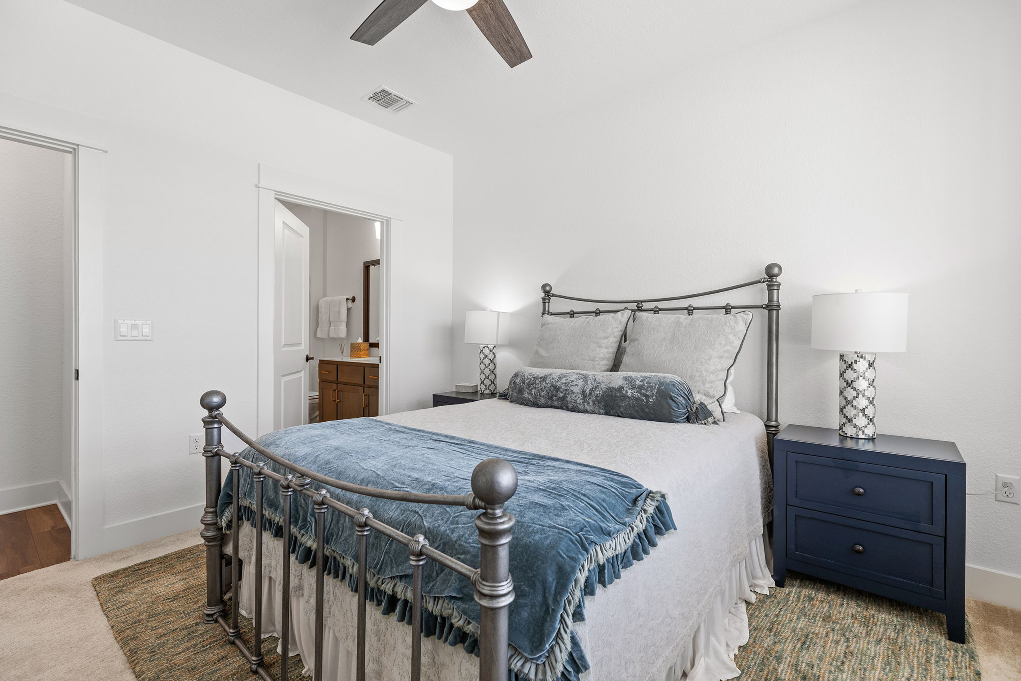 640 Martingale Street Georgetown, TX 78633 - Photo 10 of 39 Secondary Bedroom with light carpet, ensuite bathroom, and ceiling fan