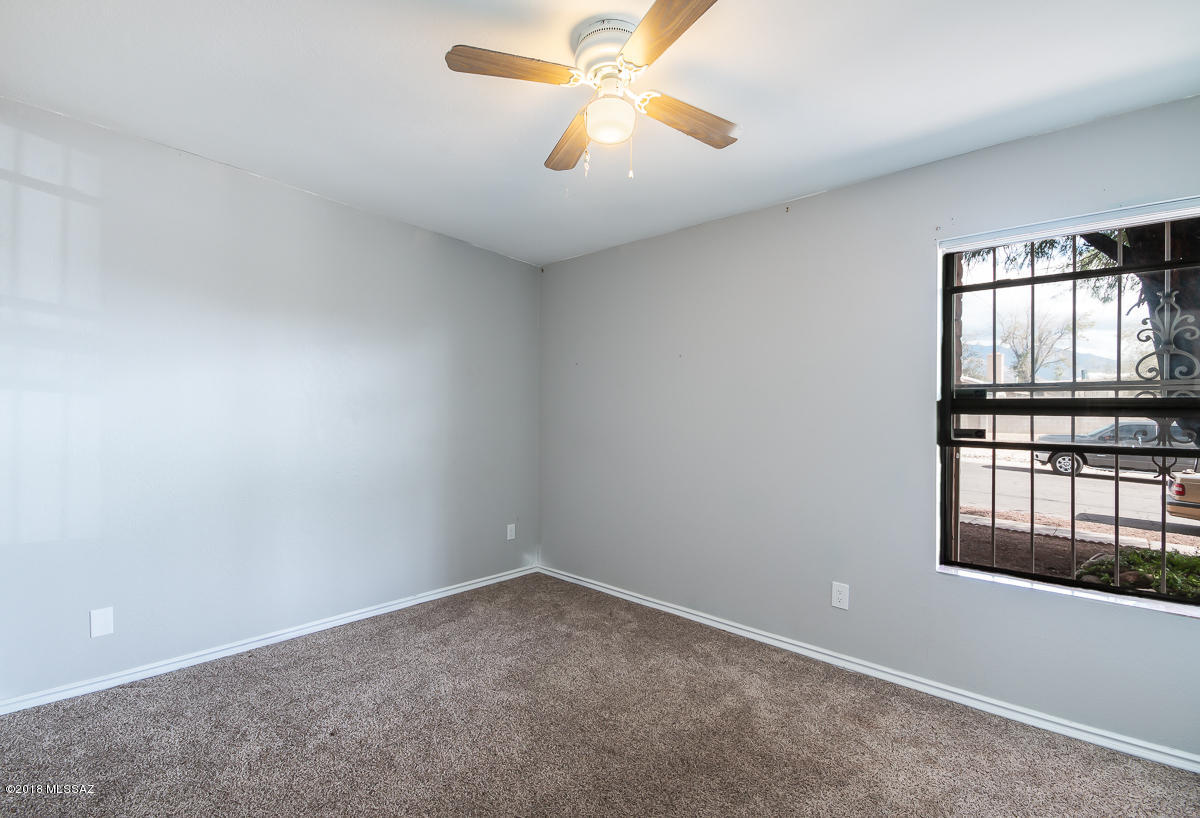 7761 North Rasmussen Avenue Tucson, AZ 85741 - Photo 12 of 23 an empty room with windows and ceiling fan