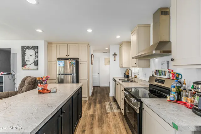 a kitchen with a stove a refrigerator and a sink
